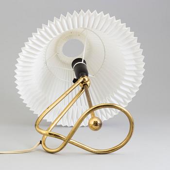 A Le Klint brass table or wall lamp.