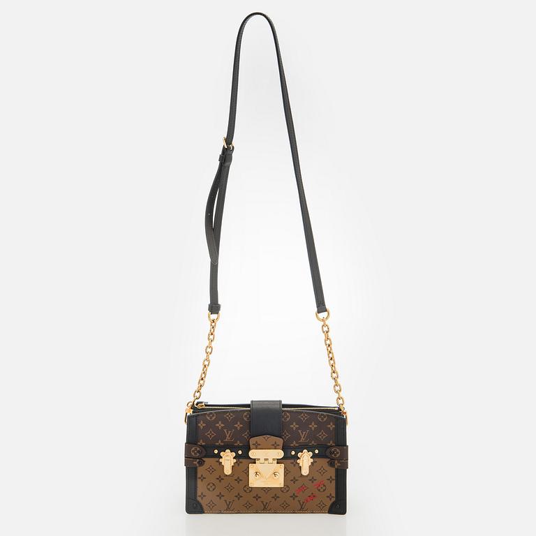Louis Vuitton, a "Reverse Monogram Trunk Clutch" bag.