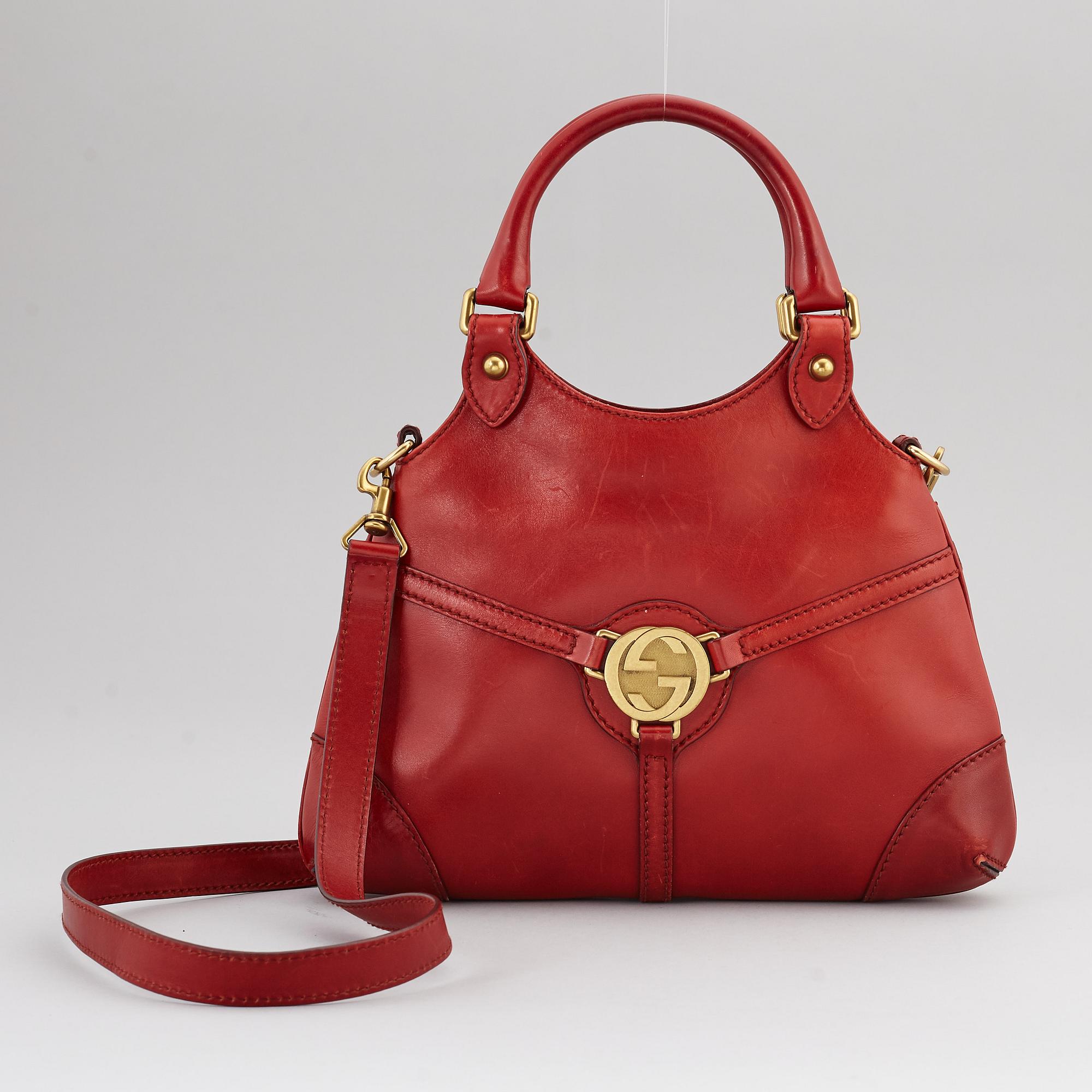 GUCCI, a red leather crossbody bag.