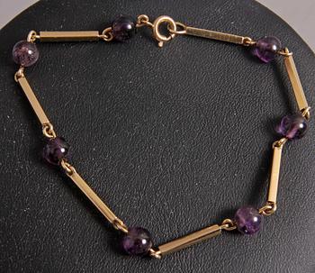 HALSBAND o ARMBAND, guld 18 K, m violetta stenar.