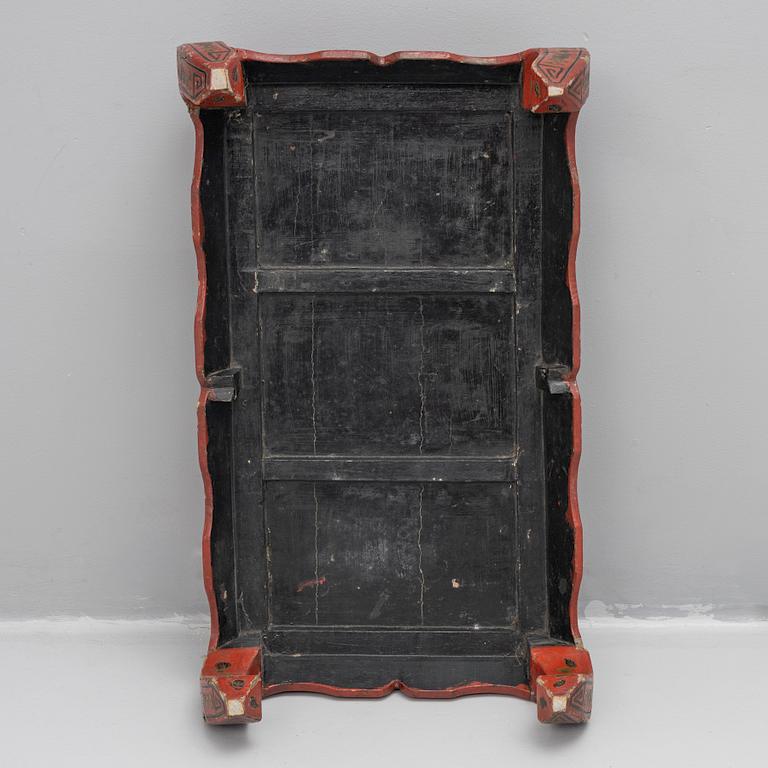 A Chinese red lacquered table, first quater of the 20th century.