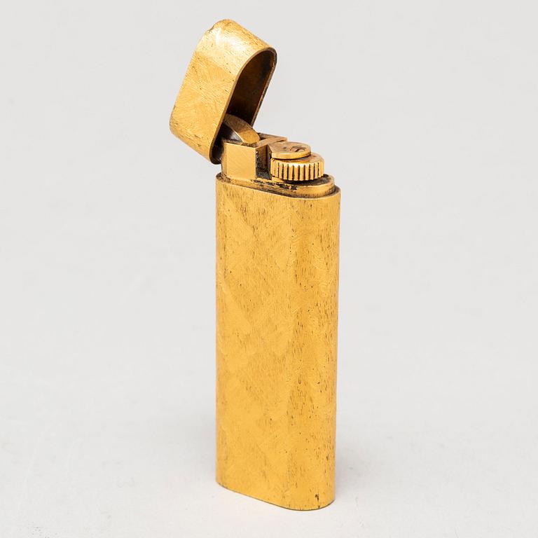 A gilt steel lighter from les must de Cartier.