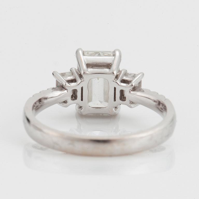 A RING set with an emerald-cut diamond.
