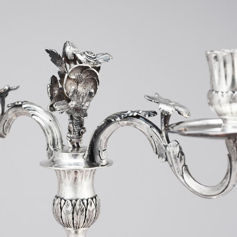 A pair of Swedish 18 century silver candelabras, mark of Lars Åkerblom Gävle 1775, arms by Christian Kullberg.