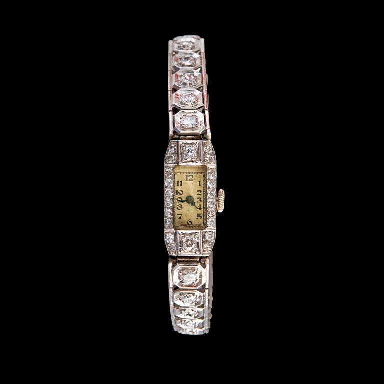 A JEWELLEY WATCH, Brilliant- and 8/8 cut diamonds c. 3.2 ct. Platinum. Swiss clockwork 1920 s. Weight 23 g.