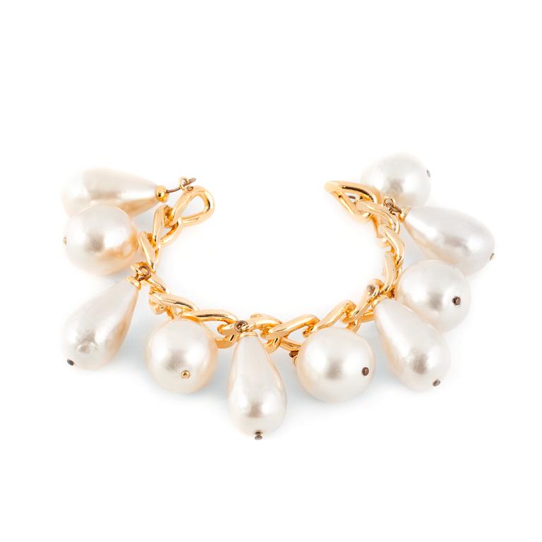 CHANEL, a goldcolored bracelet with decorative pearls.