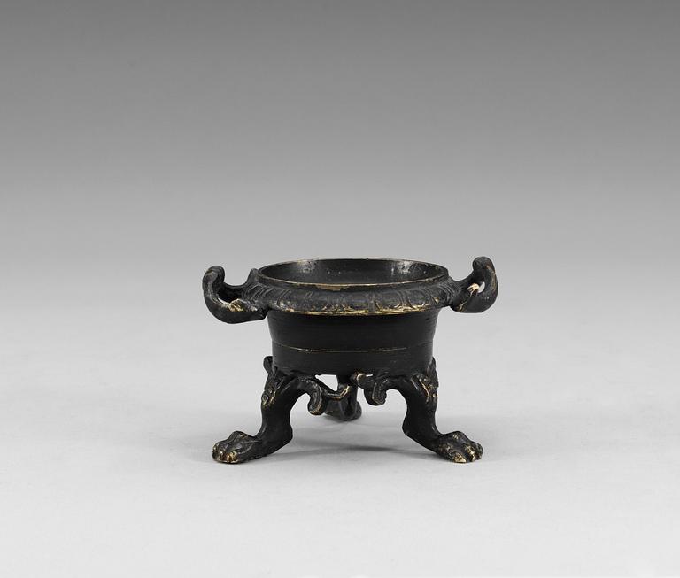 A bronze salt cellar.