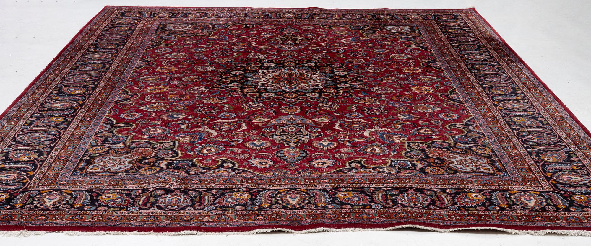 An Oriental carpet, approx. 380 x 304 cm.