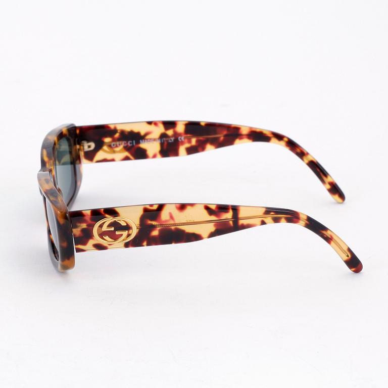 GUCCI, a apair of sunglasses.