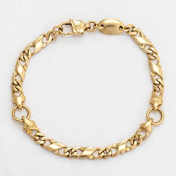 An 18k gold bracelet.