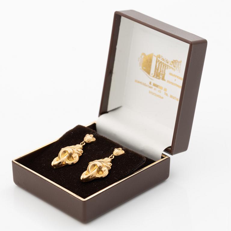 A pair of 18K gold earrings.