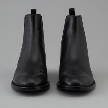 Black leather boots by Yves Saint Laurent.