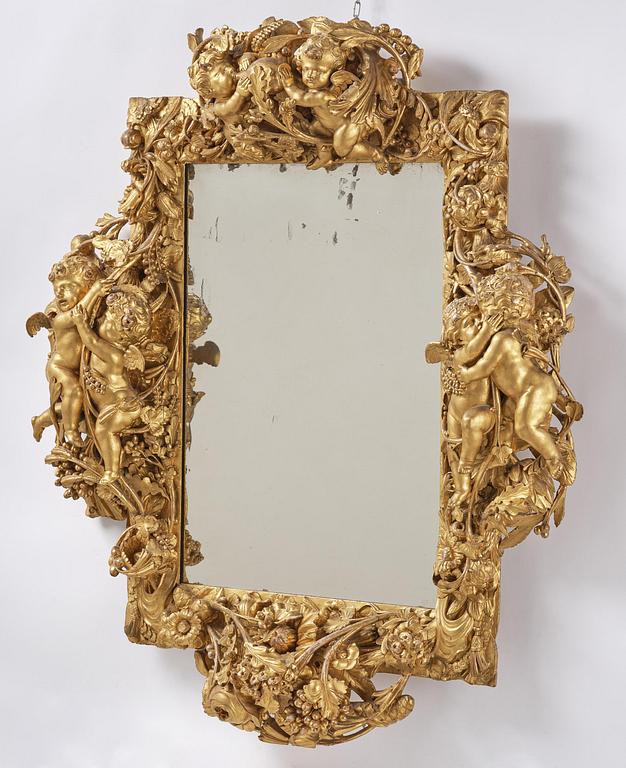 A presumably Dutch Louis XIV carved giltwood frame with mirror glass, in the style of Jean Le Pautre, late 17th century.