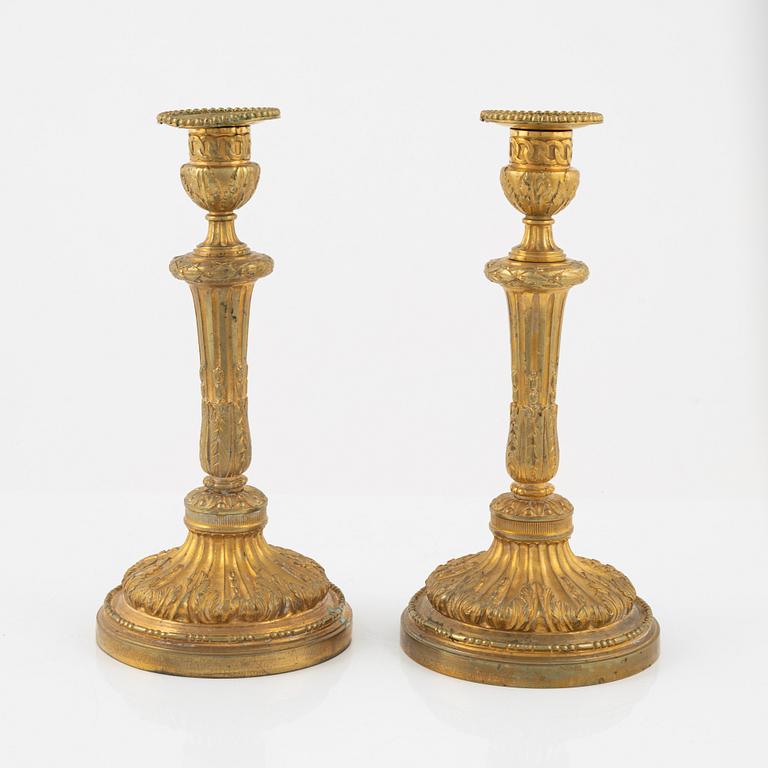 A pair of bronze candle sticks, 20th Century.