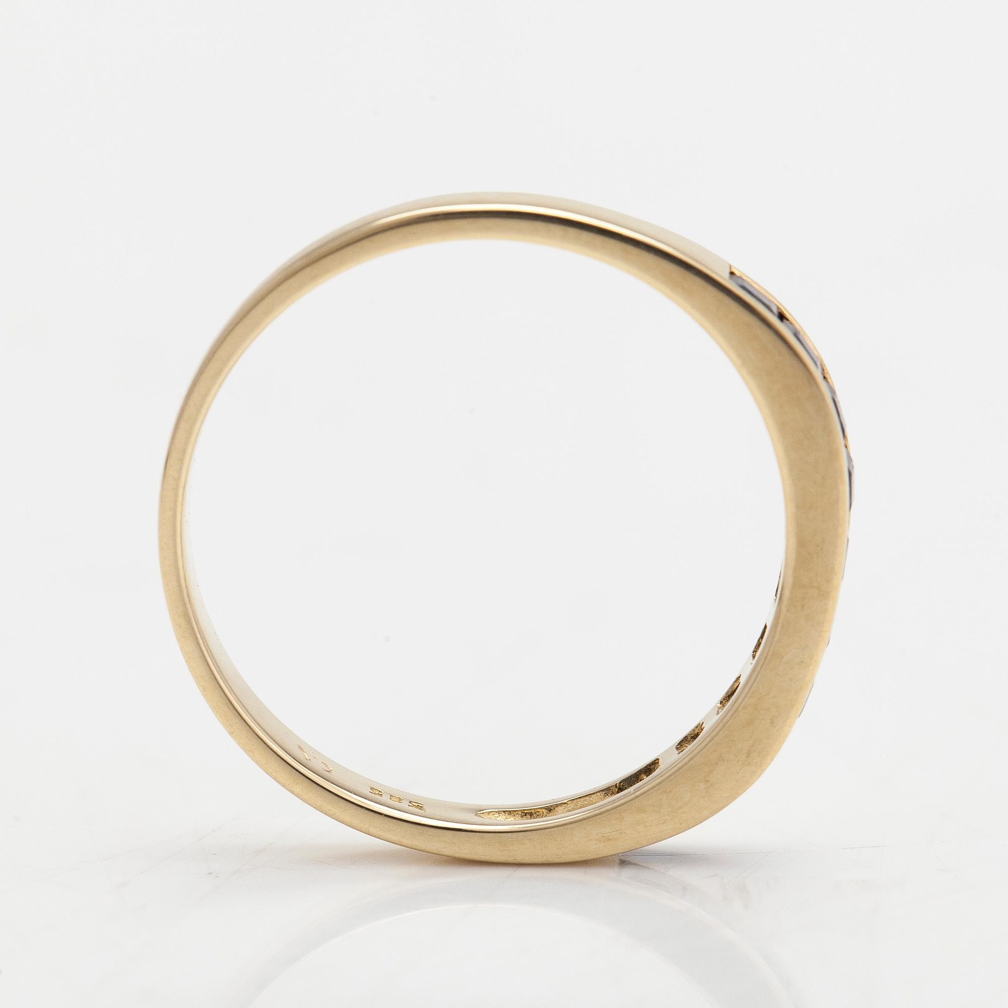 A half-eternity 14K gold ring with sapphires.