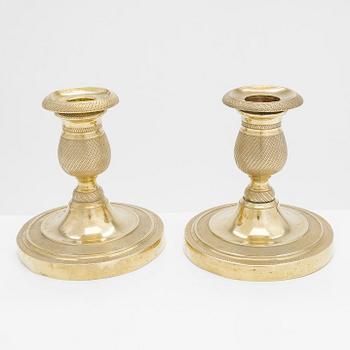 A pair of early 19th century French gilded Empire candlesticks.