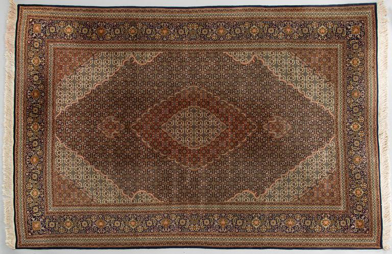 A Tabriz part silk carpet, Mahi, c. 297 x 200 cm.