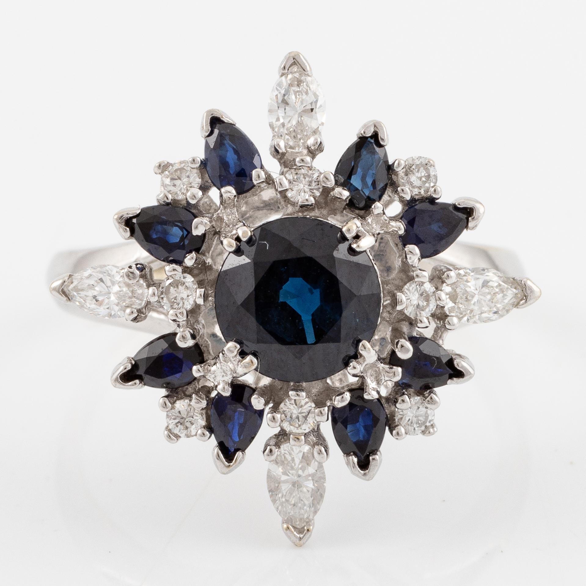Ring 18K white gold with dark sapphires, pear-shaped and brilliant-cut diamonds.
