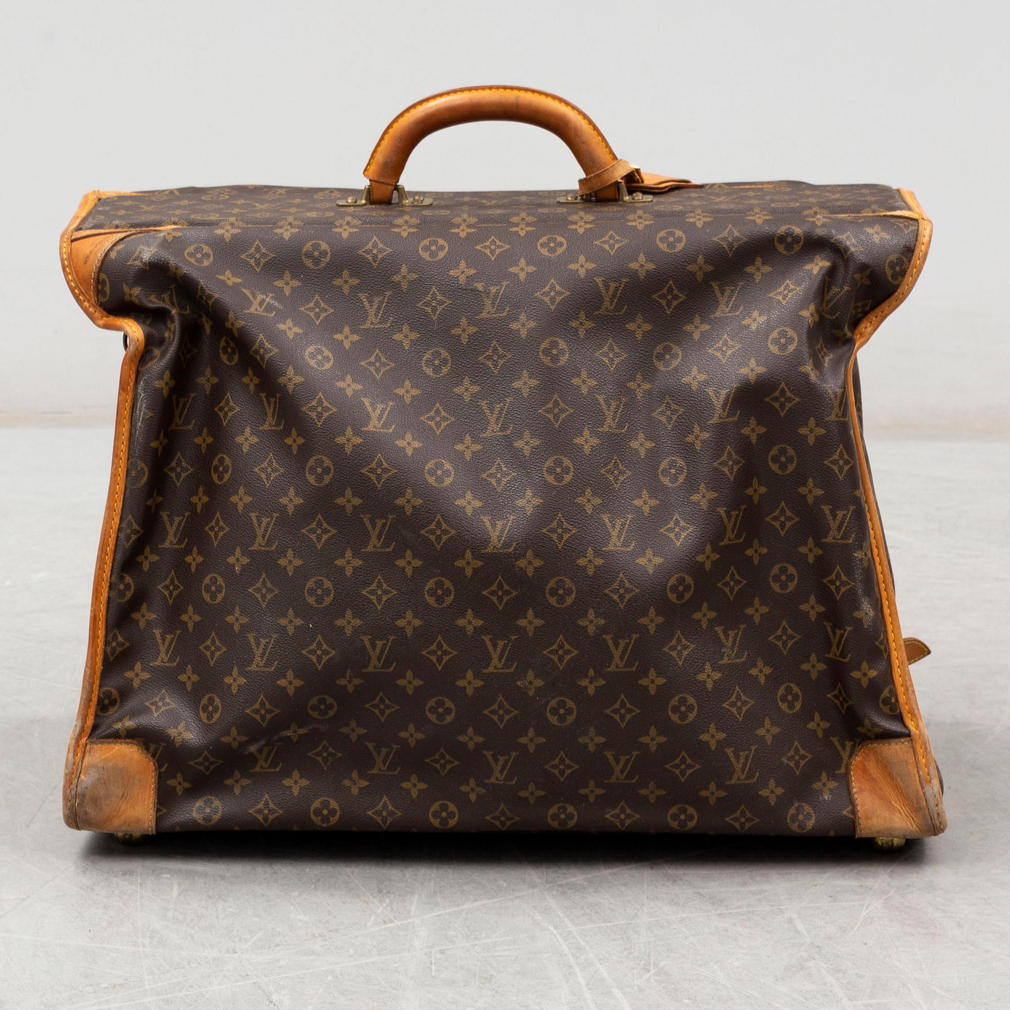 LOUIS VUITTON, a monogram canvas garment bag.