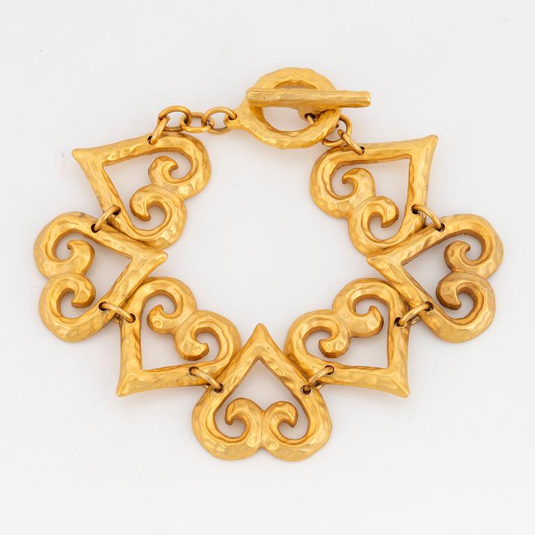 YVES SAINT LAURENT, Hammered gilt metal bracelet, links designed as hearts.