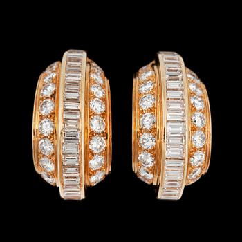 965. A pair of Cartier diamond earrings. Total carat weigh circa 5.00 cts.