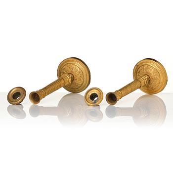 A pair of French Empire ormolu candlesticks, early 19th century.