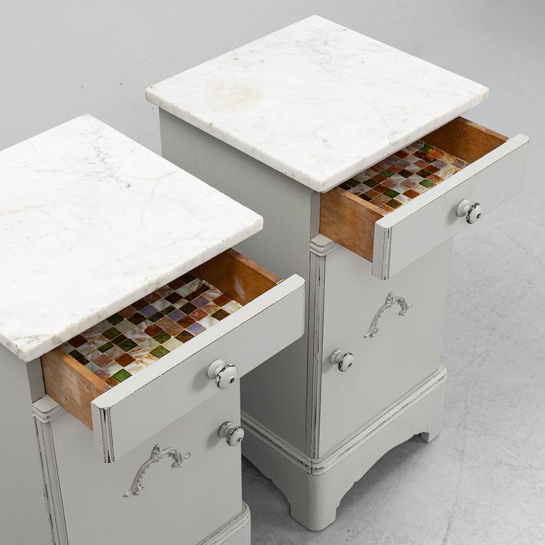 A pair of marble top bedside tables, first half of the 20th Century.