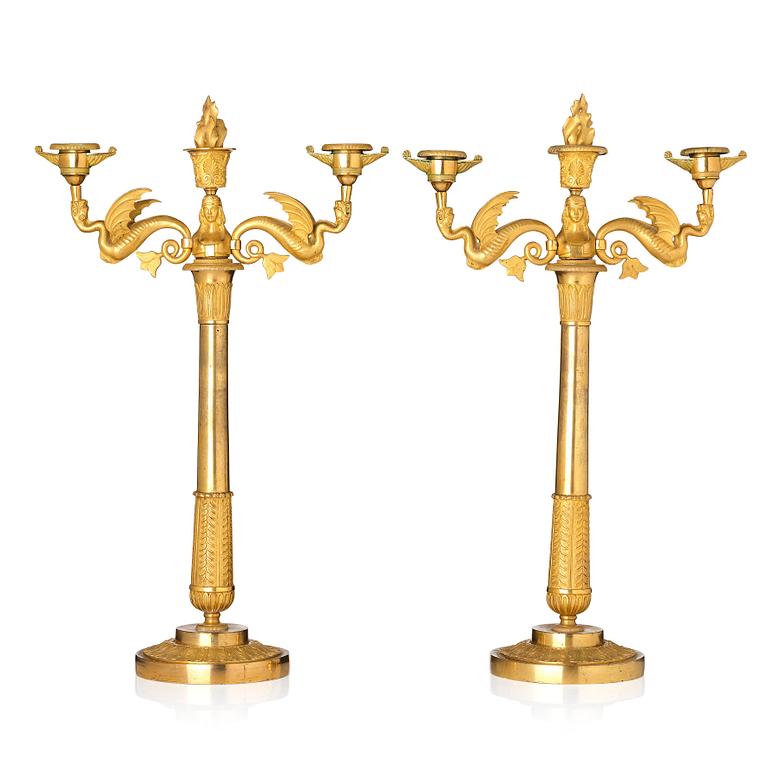 A pair of ormolu three-branch Empire candelabra, early 19th century.