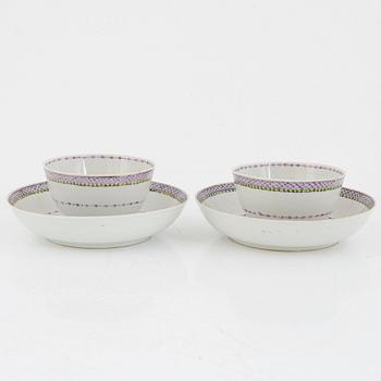 A pair of Chinese famille rose cups with saucers and a cup, Qing dynasty, 18th century.