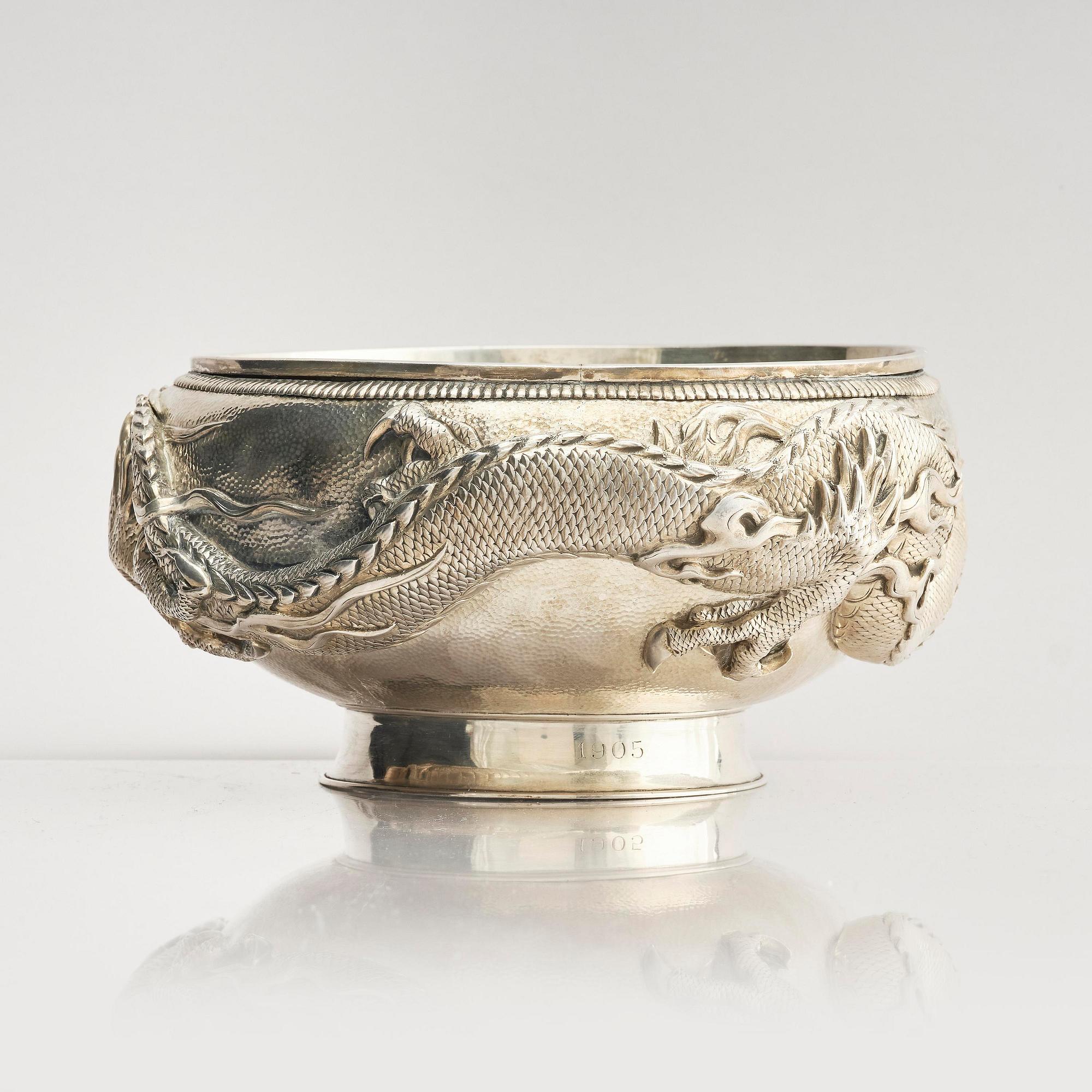 A Chinese double walled 'dragon' silver bowl, Shanghai, around 1900.
