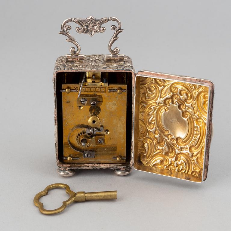 A rococo-style silver clock, mark of Henry Matthews, Chester 1903.