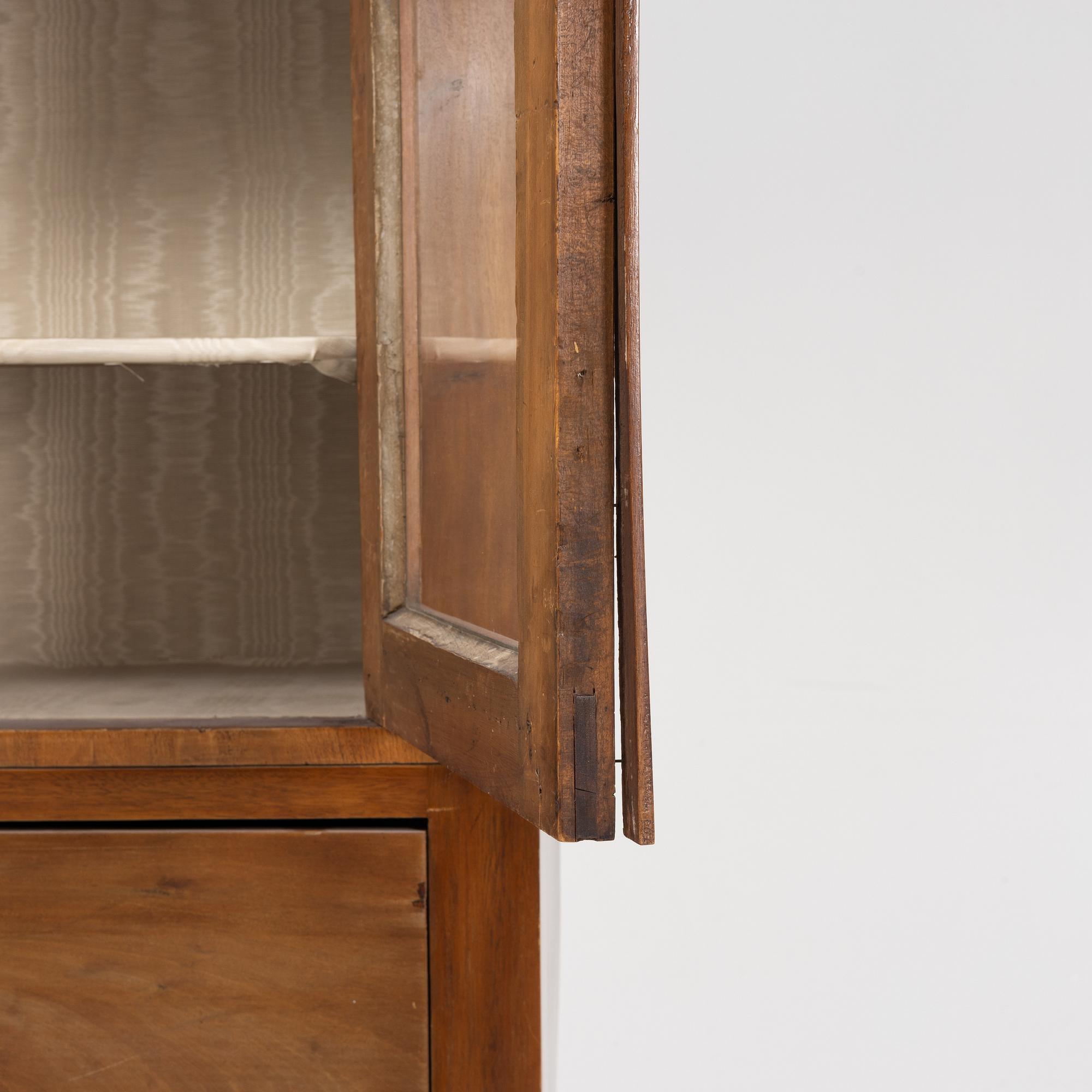 A mahogany veneered book cabinet. 19th Century.