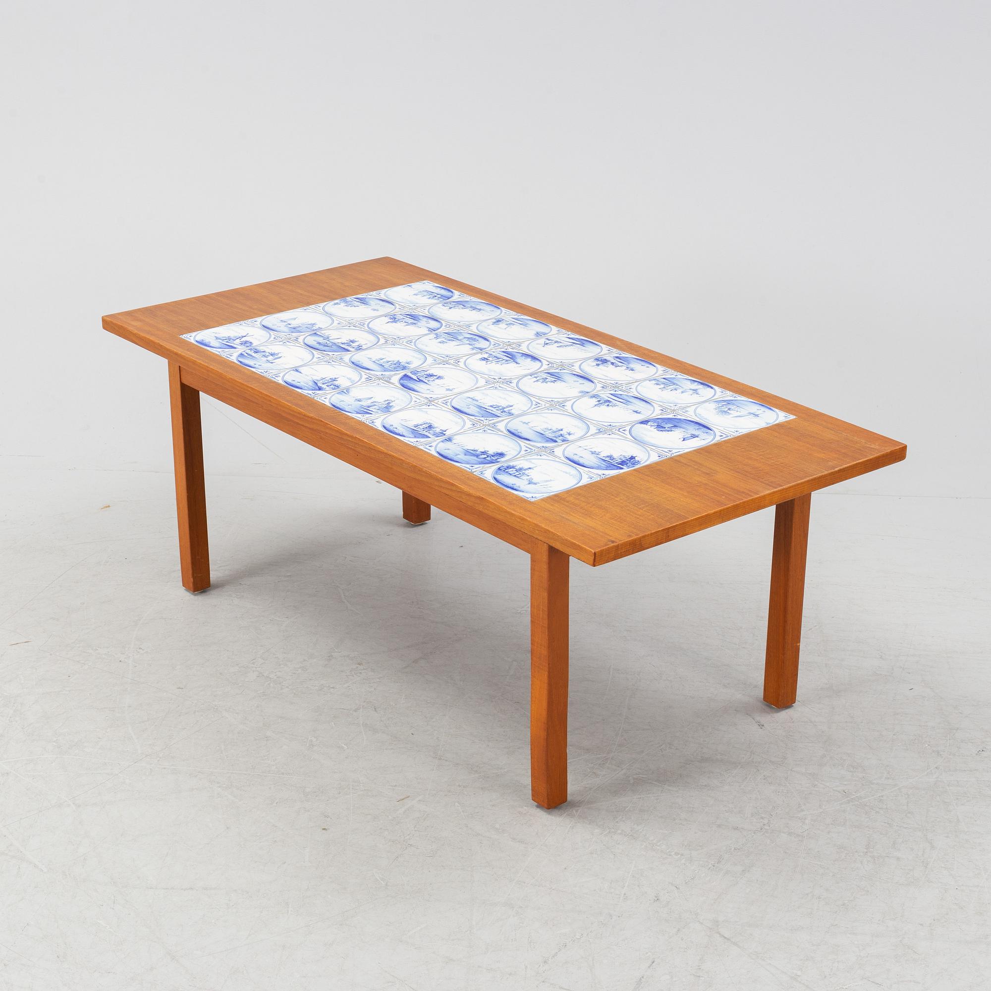A teak coffee table with inlaid tiles. Second half of the 20th Century.