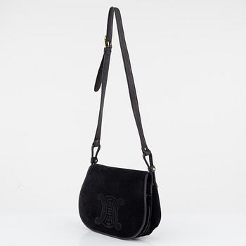 Céline, a black suede handbag.