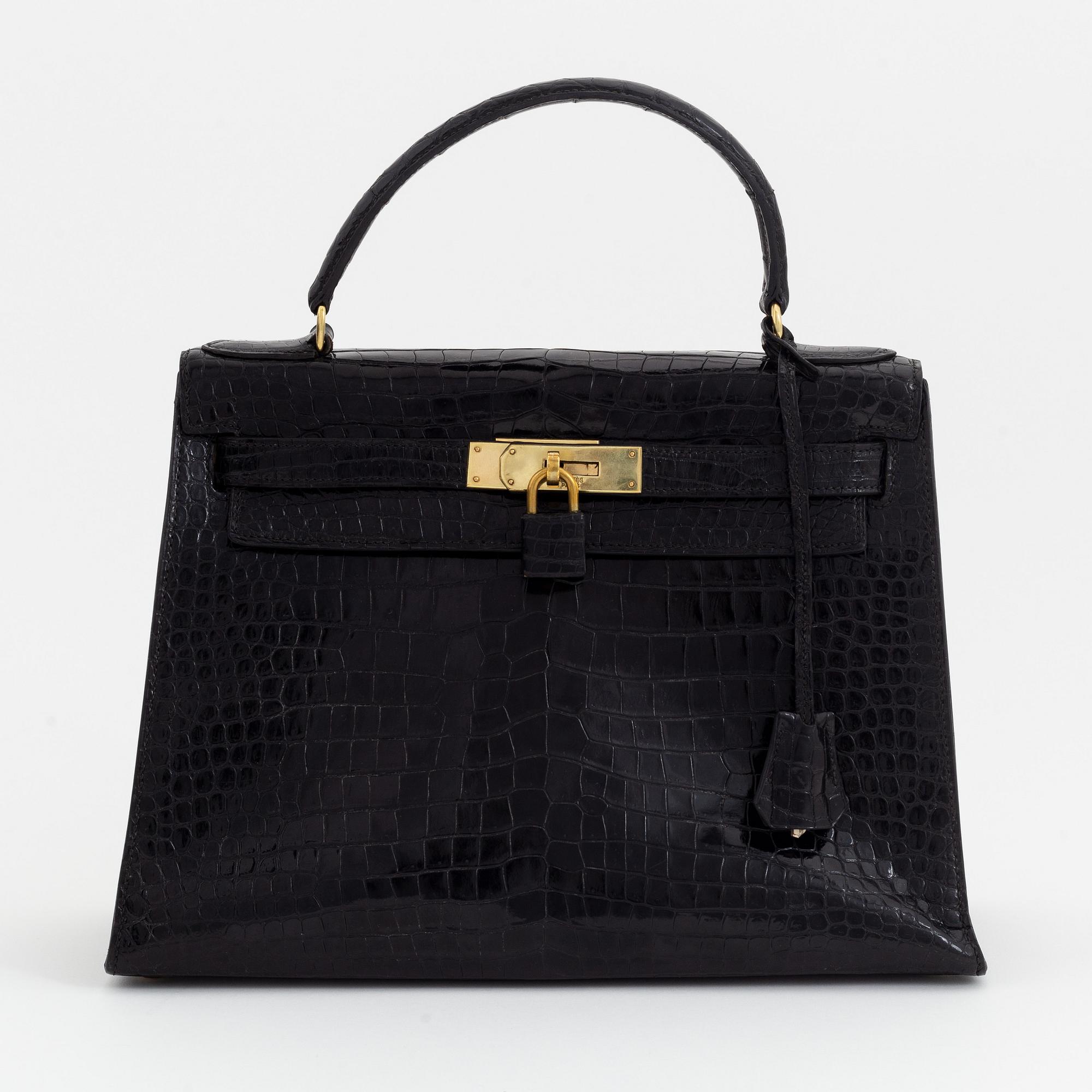1962 black alligator 'Kelly' handbag by Hermès.