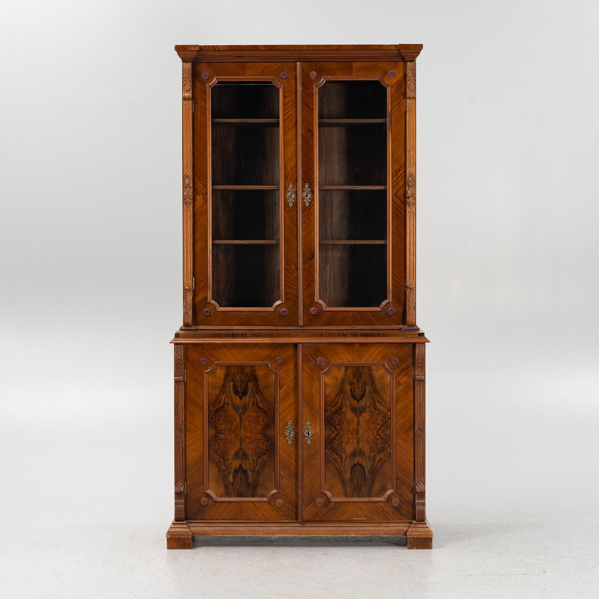 A walnut veneered book cabinet, second part of the 20th Century.