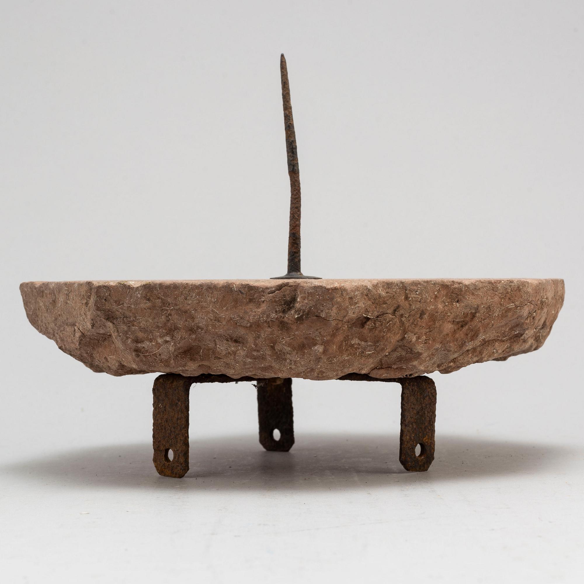 A limestone and iron sundial dated 1732.