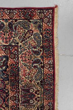 A carpet, semi-antique Kerman Laver, ca 242 x 142 cm.