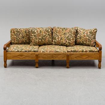 KNUT FJAESTAD, a folk art stained wood sofa/bed,  Sweden, early 20th C.