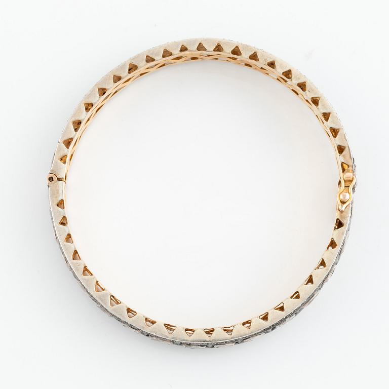 A faceted diamond bangle.