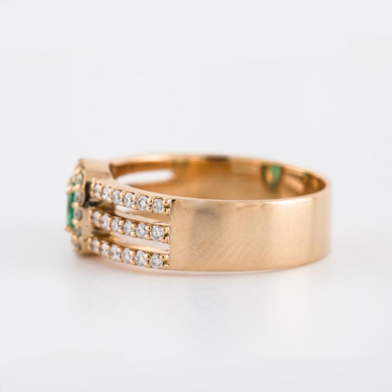 A faceted emerald and brilliant cut diamond ring.