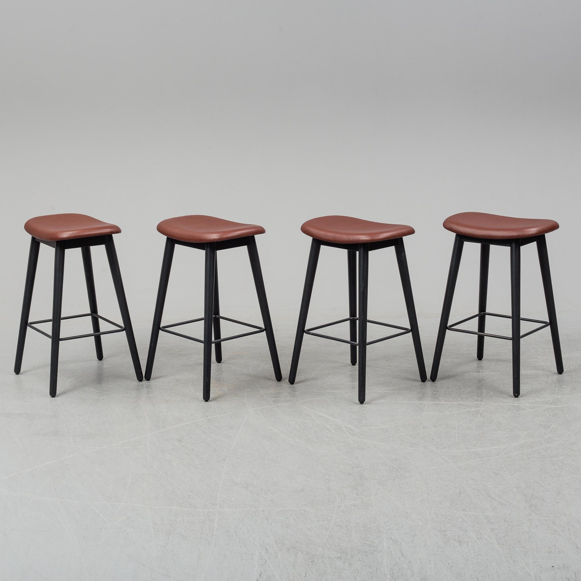 Four contemporary leather upholstred stools by Berlin & Iskos for Muuto.