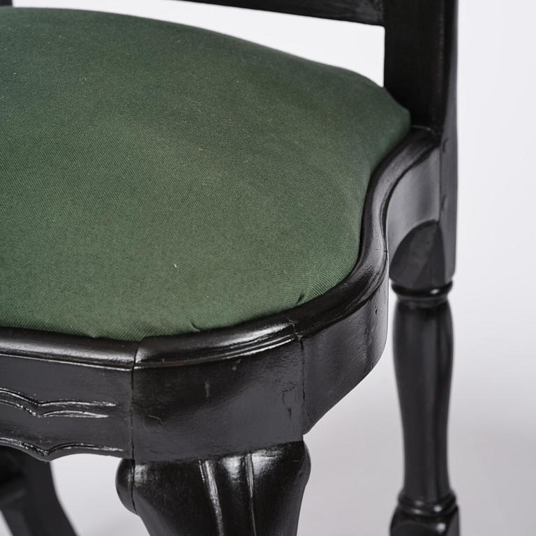 A set of eight black Swedish rococo chairs.