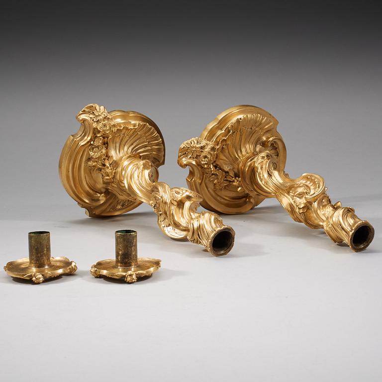 A pair of Louis XV 18th century gilt bronze candlesticks after the model by Juste-Aurèle Meissonnier.