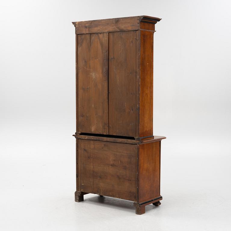 A mahogany veneered book cabinet, around 1900.