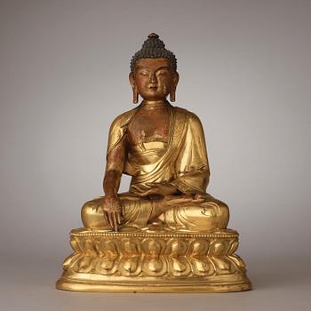 A finely cast Tibeto-Chinese gilt bronze figure of Shakyamuni Buddha, Qing dynasty, circa 1800.