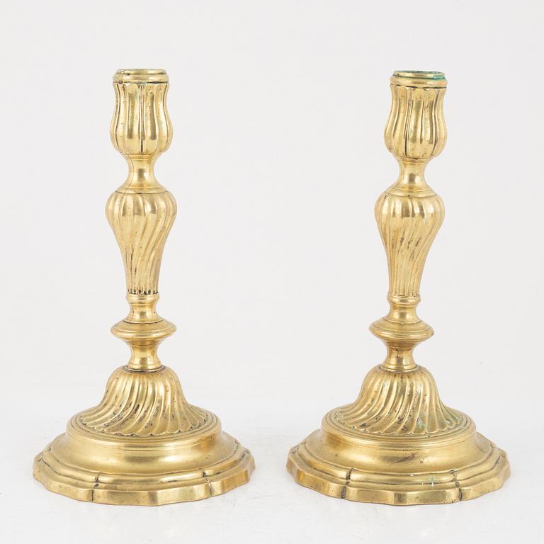 A pair of French Louis XV brass candlesticks, mid 18th century.