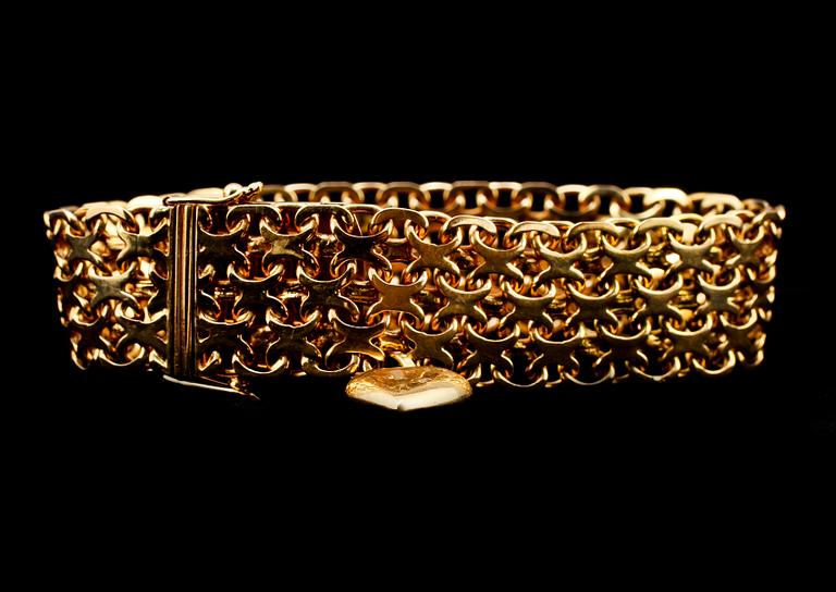 ARMBAND, 18k guld, länk med en berlock, Stockholm, 1958. Vikt 40 g.