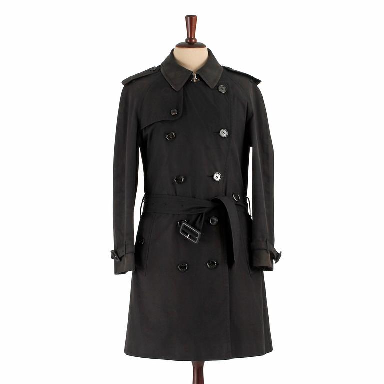 BURBERRY, a black cotton trenchcoat.