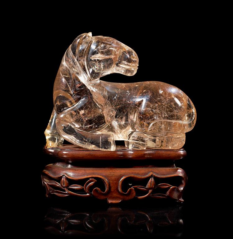 A smoky quartz figure of a reclining horse, China early 20th Century.
